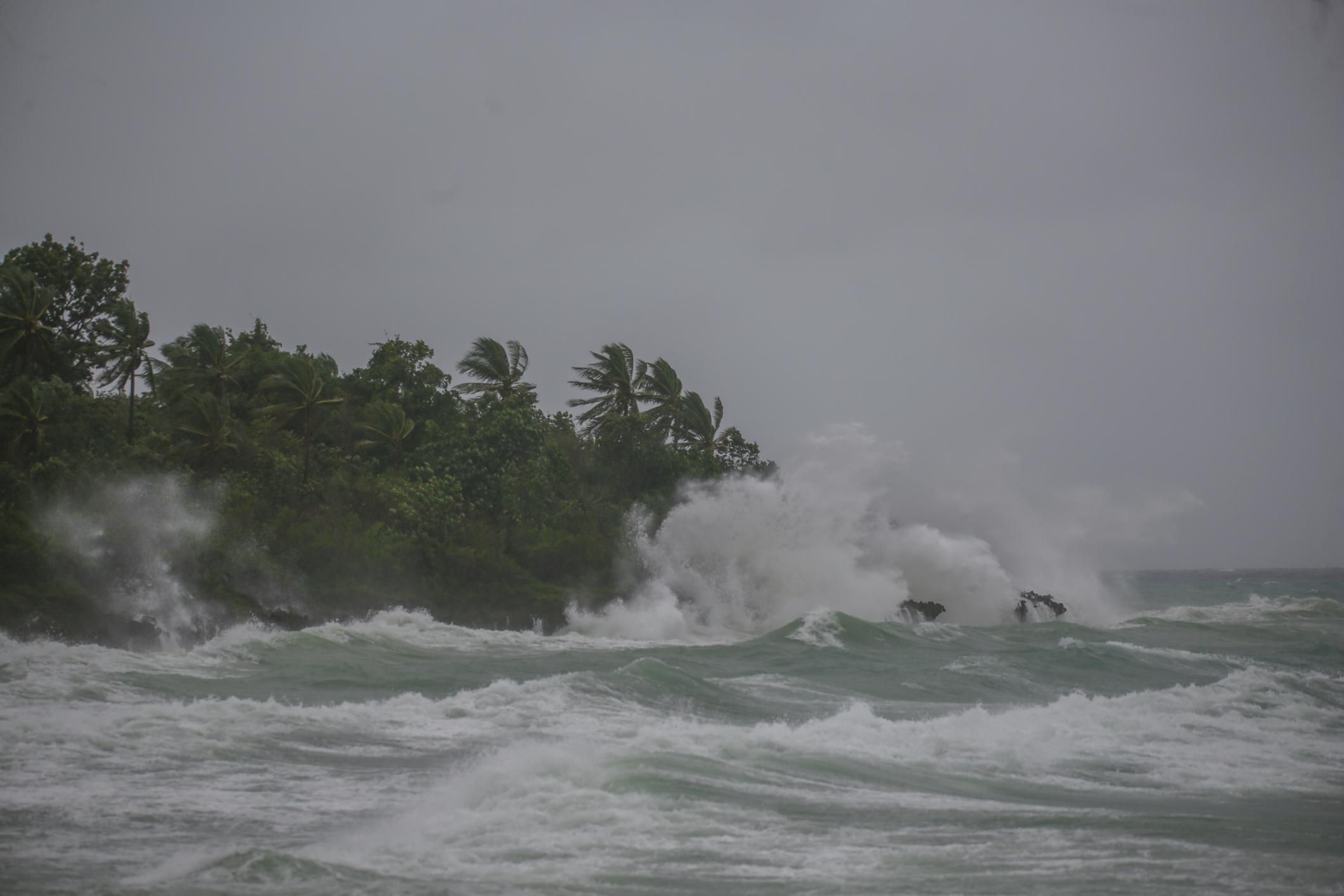 High tides crash on a tropical shore during a hurricane.