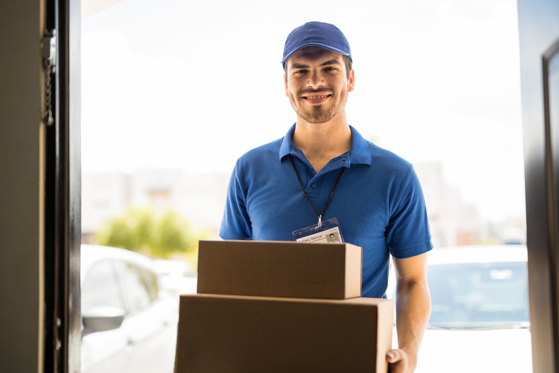 A man delivers boxes to a business.