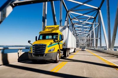 Penske tractor driving over bridge
