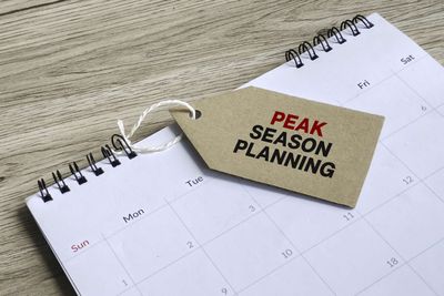 An empty calendar with a tag that reads "PEAK SEASON PLANNING"