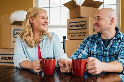 people with penske moving boxes