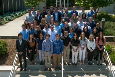 Interns stand outside the company headquarters on the stairs in Green Hills, Pennsylvania.