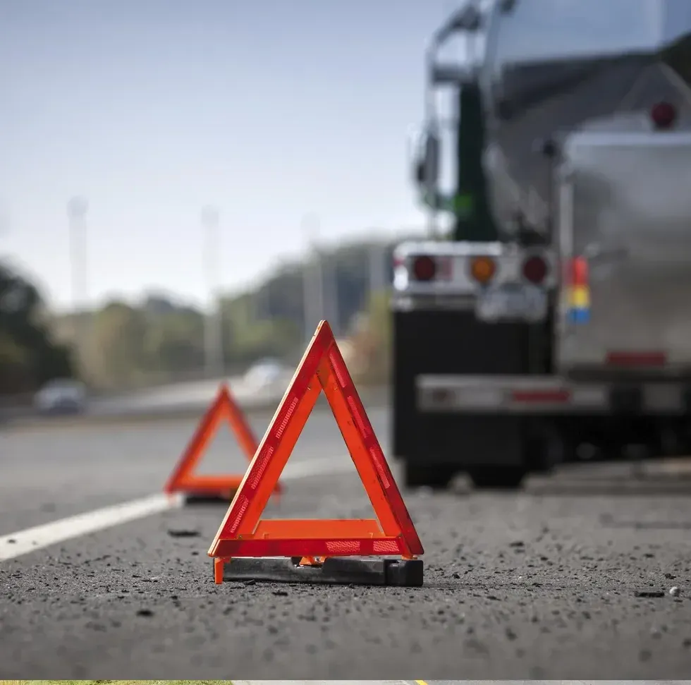 Caution triangles on the road warning of a stopped truck