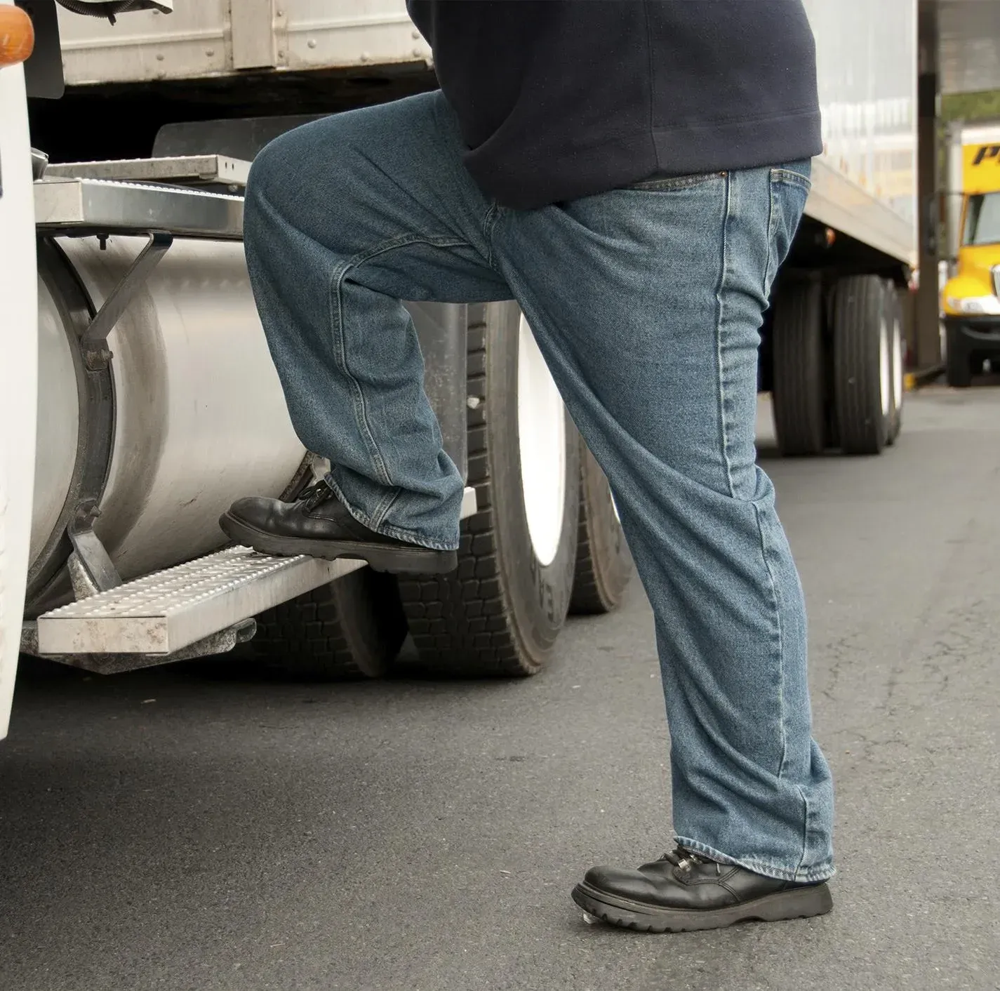 A truck driver steps into a semi truck