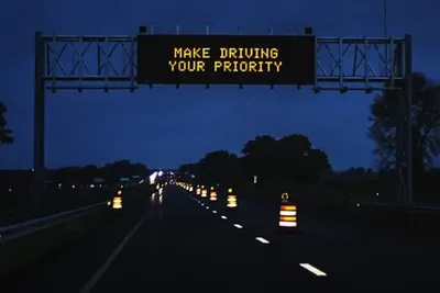 A Make Driving Your Priority highway sign